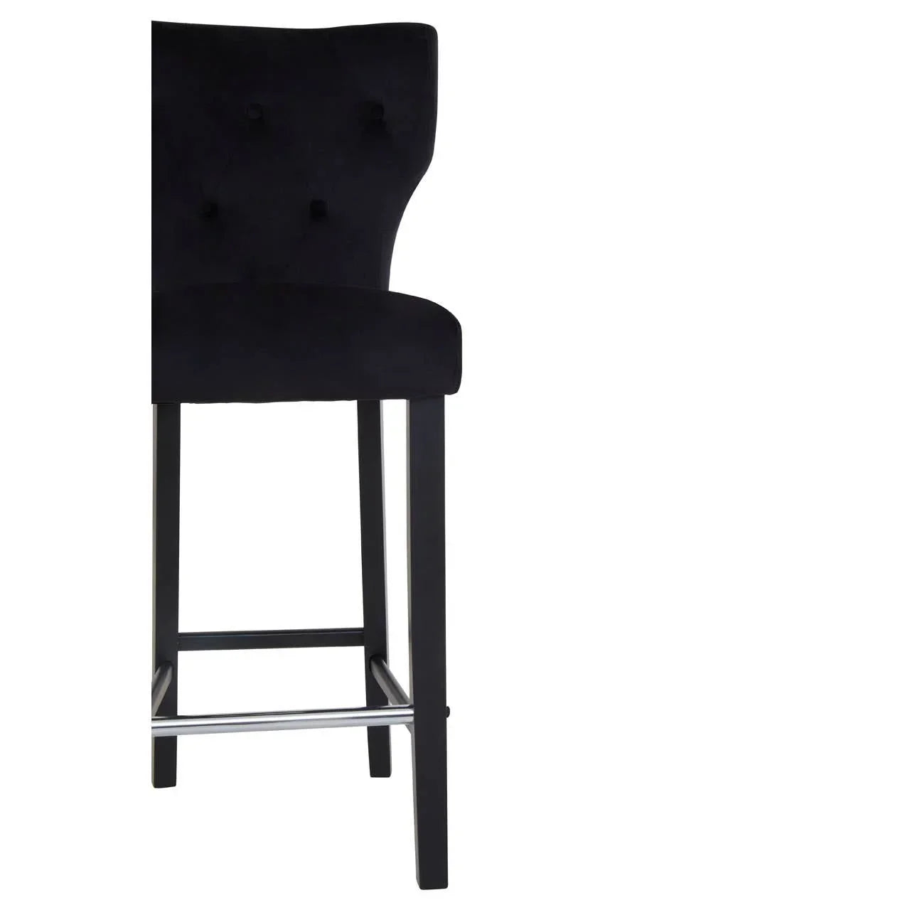 Black velvet bar stool with buttoned backrest and dark wooden legs, side view