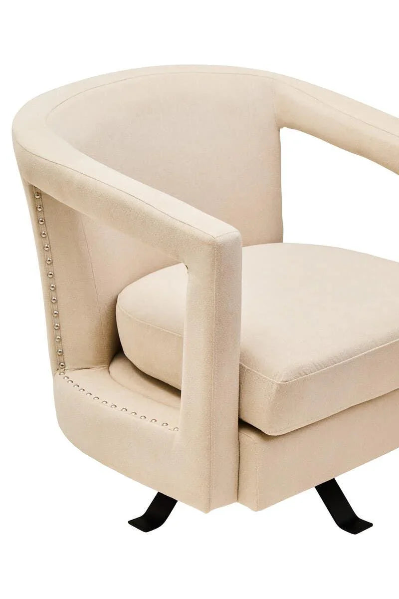 Beige fabric accent chair with studded trim and curved armrest on black metal legs