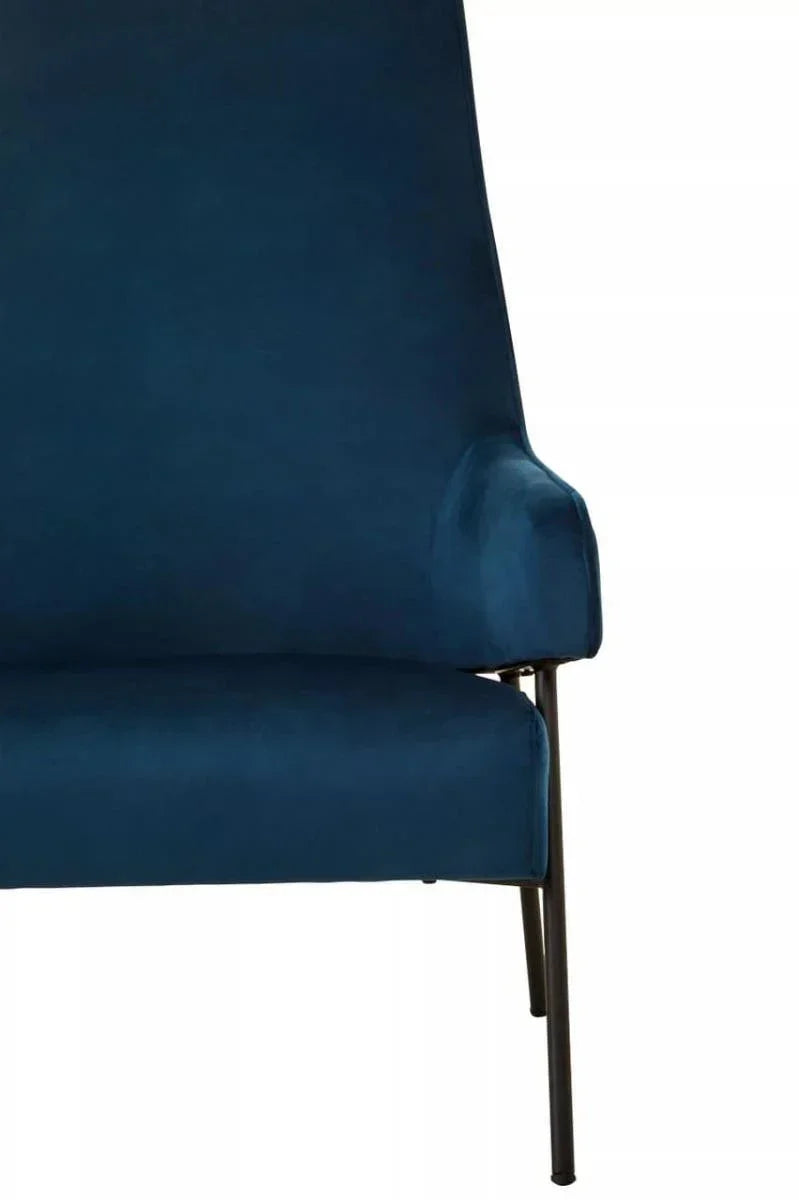 Blue velvet armchair with slim metal legs and angled backrest