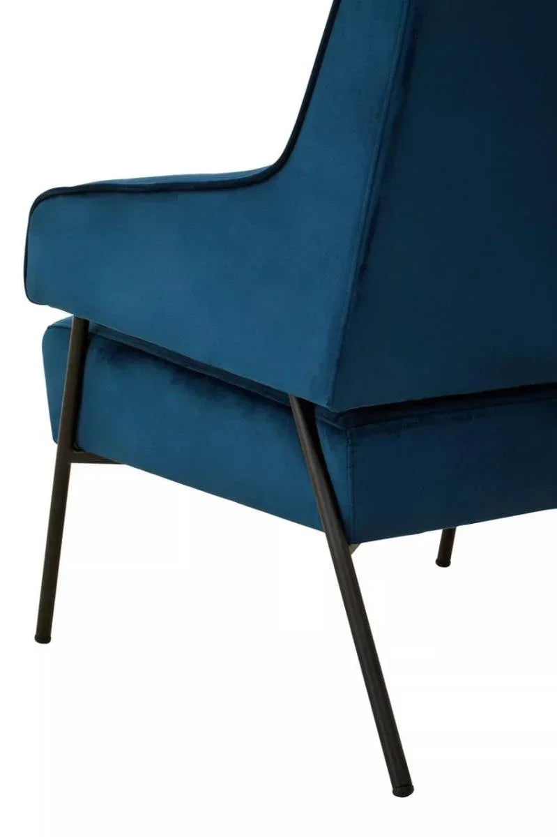 Blue velvet accent chair with angled black metal legs, side profile view