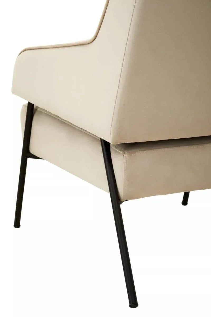 Beige armchair corner with black metal legs and fabric upholstery, side detail view