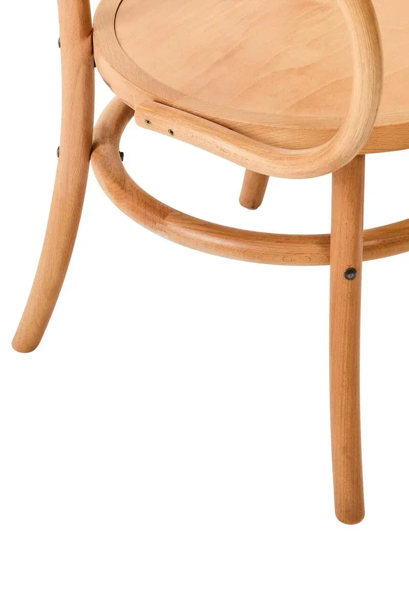 Curved light wood dining chair leg and seat detail