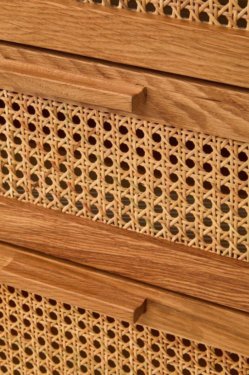 Close up of natural wood drawer with woven rattan front and integrated handle