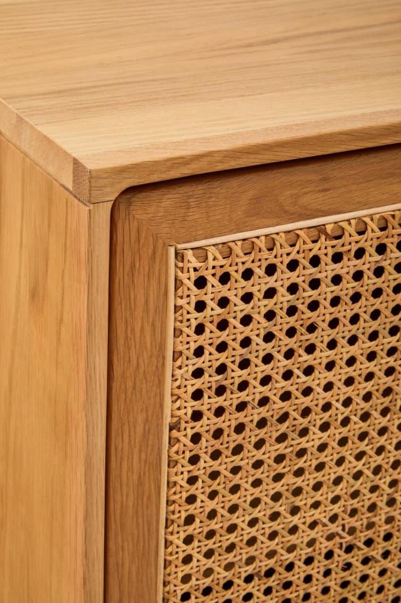 Close-up of wooden cabinet with natural cane rattan panel detail and smooth finish