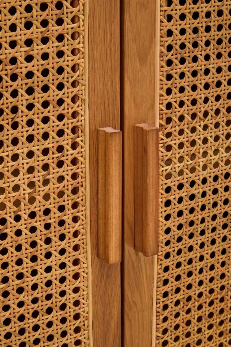 Closeup of wooden cabinet with rattan doors and vertical wood handles