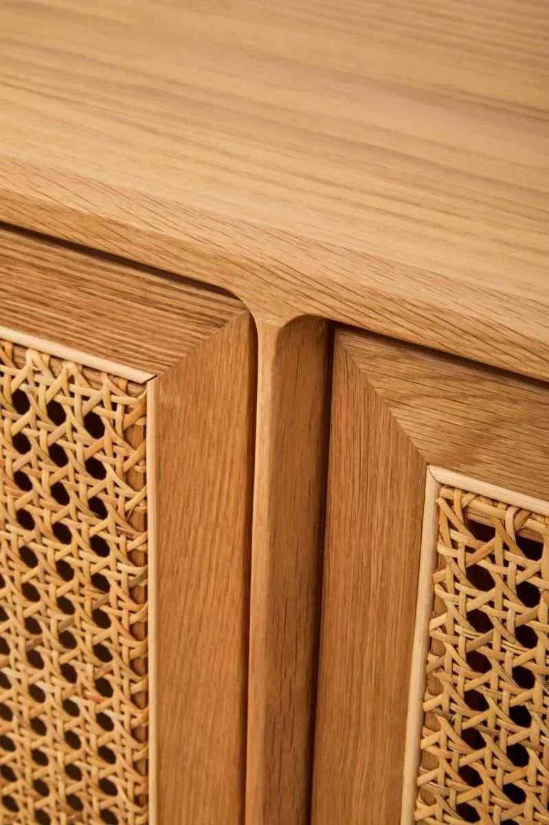 Closeup of wooden sideboard with natural rattan panel doors and smooth oak finish