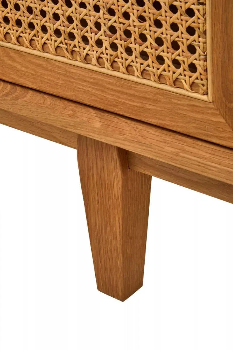 Close detail of natural oak furniture leg and rattan cane panel