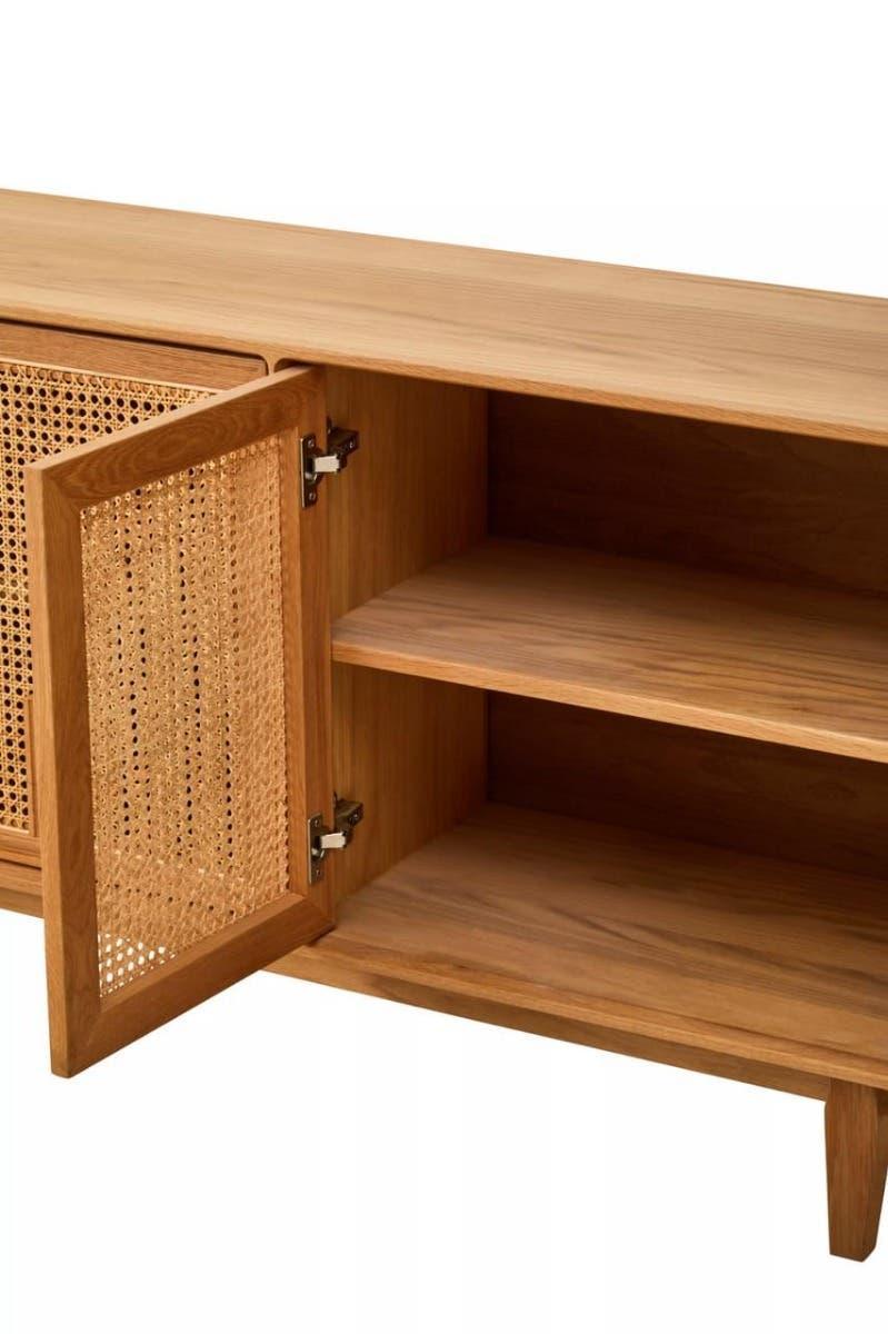 Oak sideboard with rattan door panel and open shelving, close view of interior