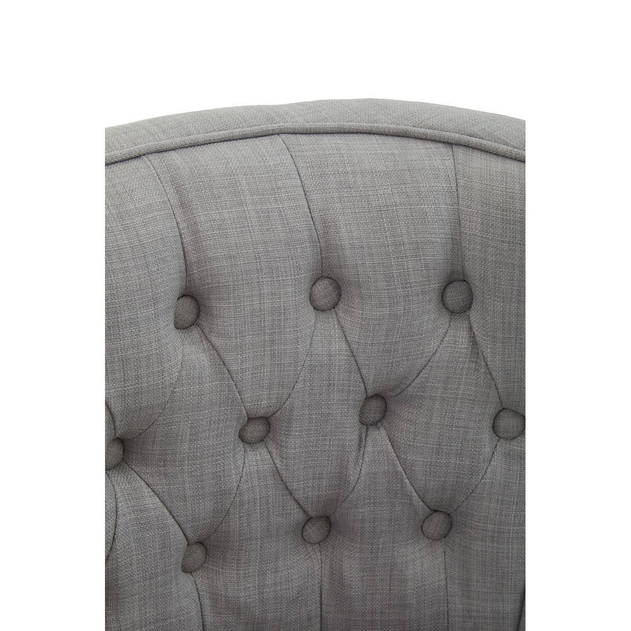 Grey fabric button-tufted sofa backrest close-up
