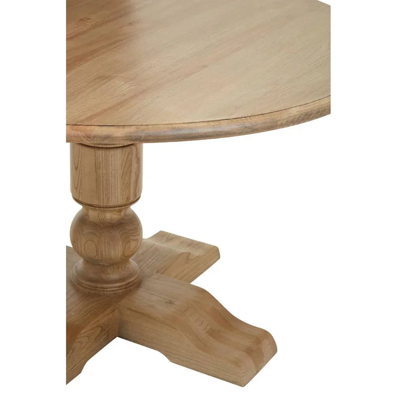 Round wooden dining table with carved pedestal base in light wood finish, close-up view