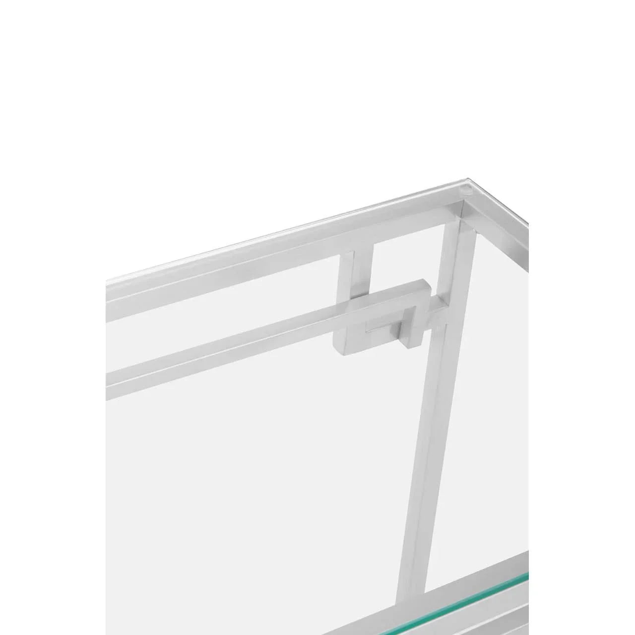 Closeup of modern glass coffee table with chrome frame and geometric side detail