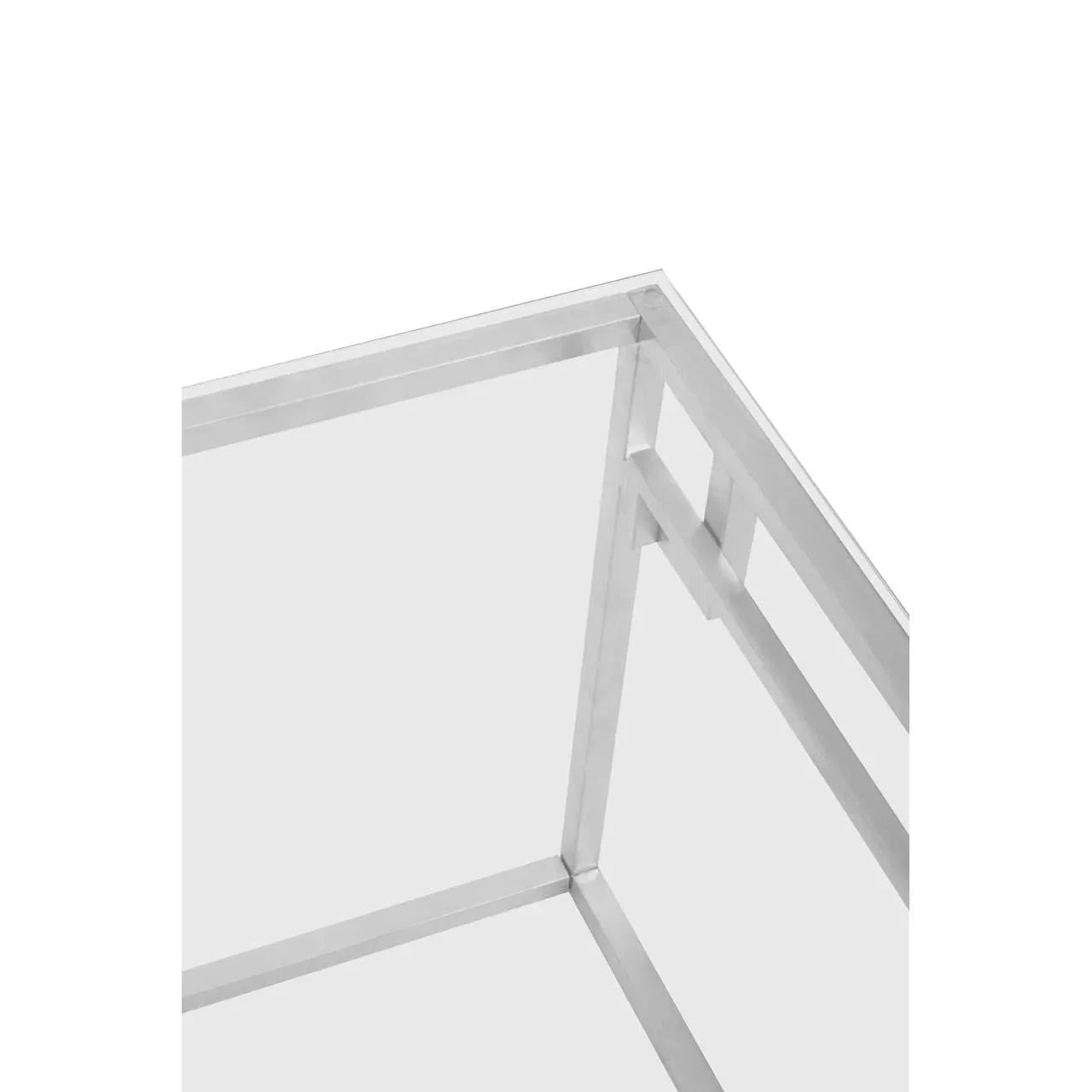Closeup of glass coffee table corner with chrome metal frame