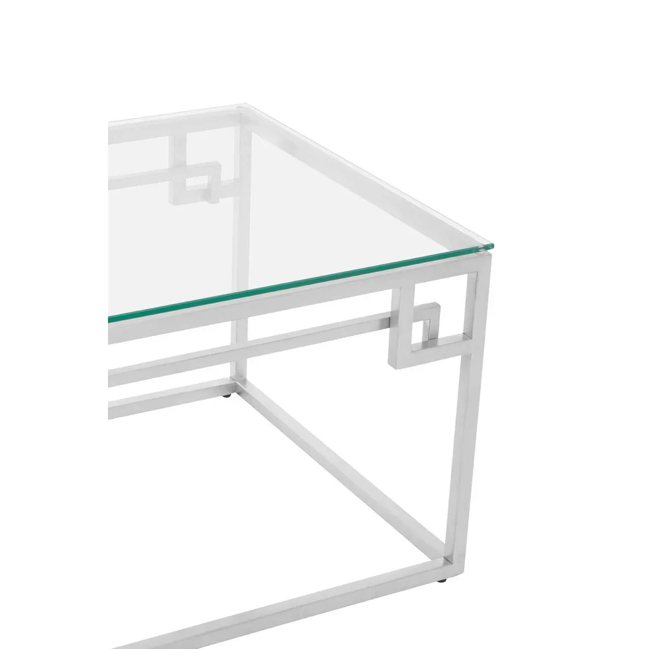 Glass coffee table with white geometric metal frame, close-up on corner detail