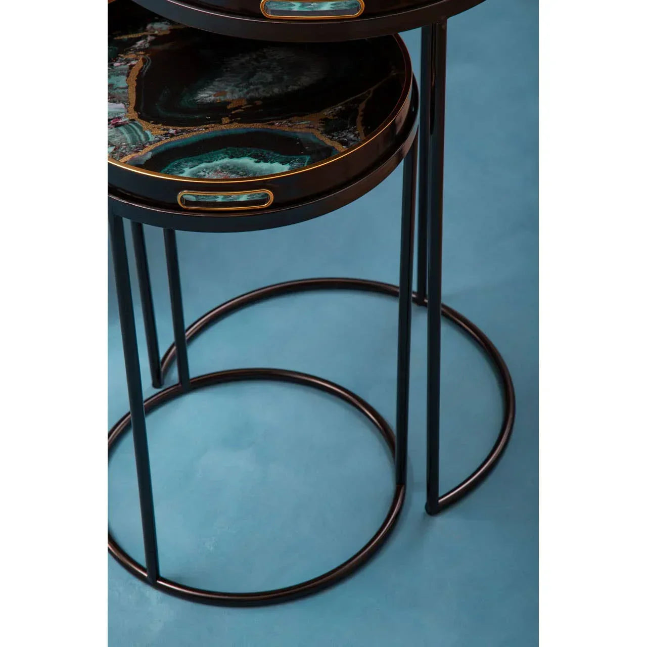 Set of round nesting side tables with black metal legs and glossy agate effect tabletops