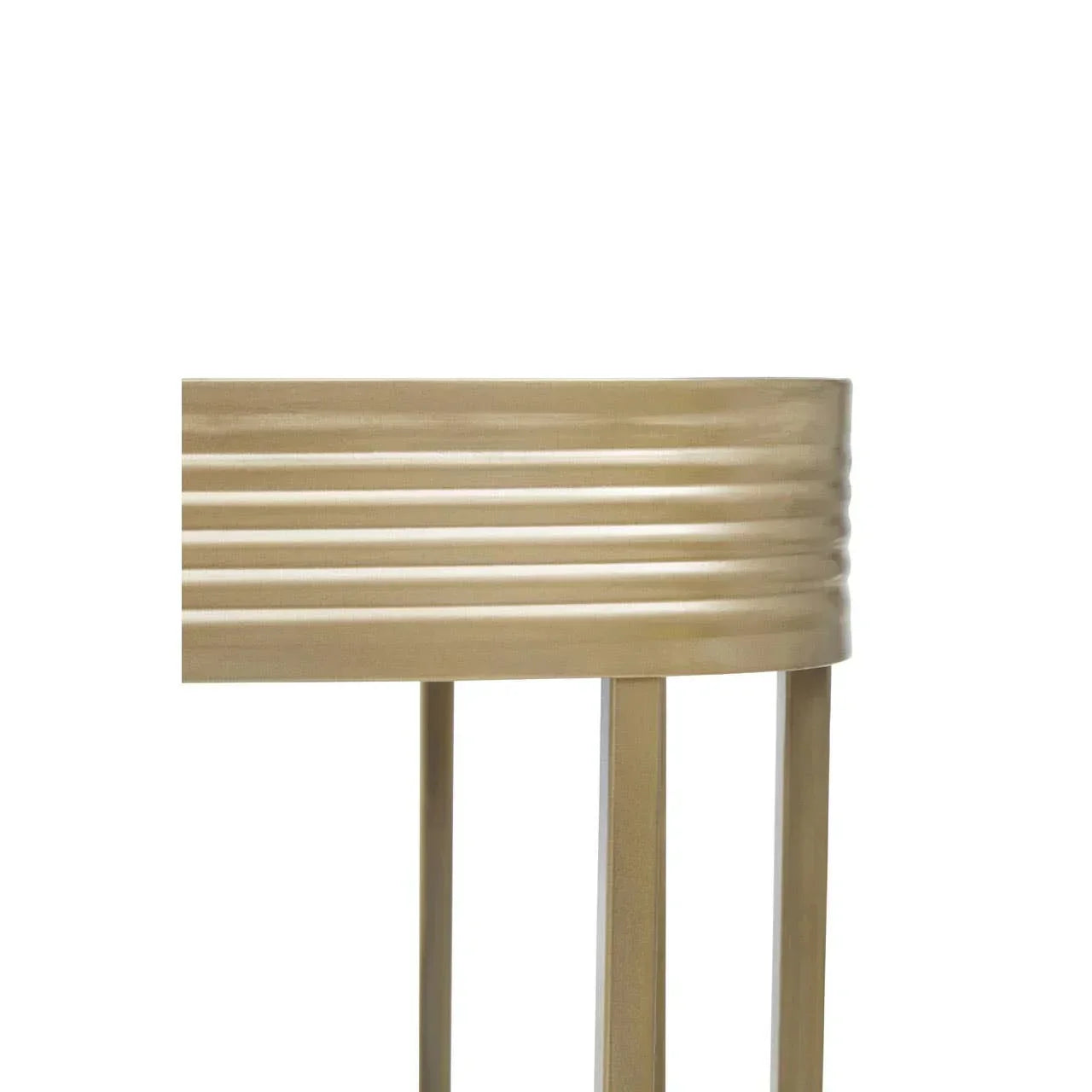 Gold metal side table with ribbed edge and slim legs, close-up view