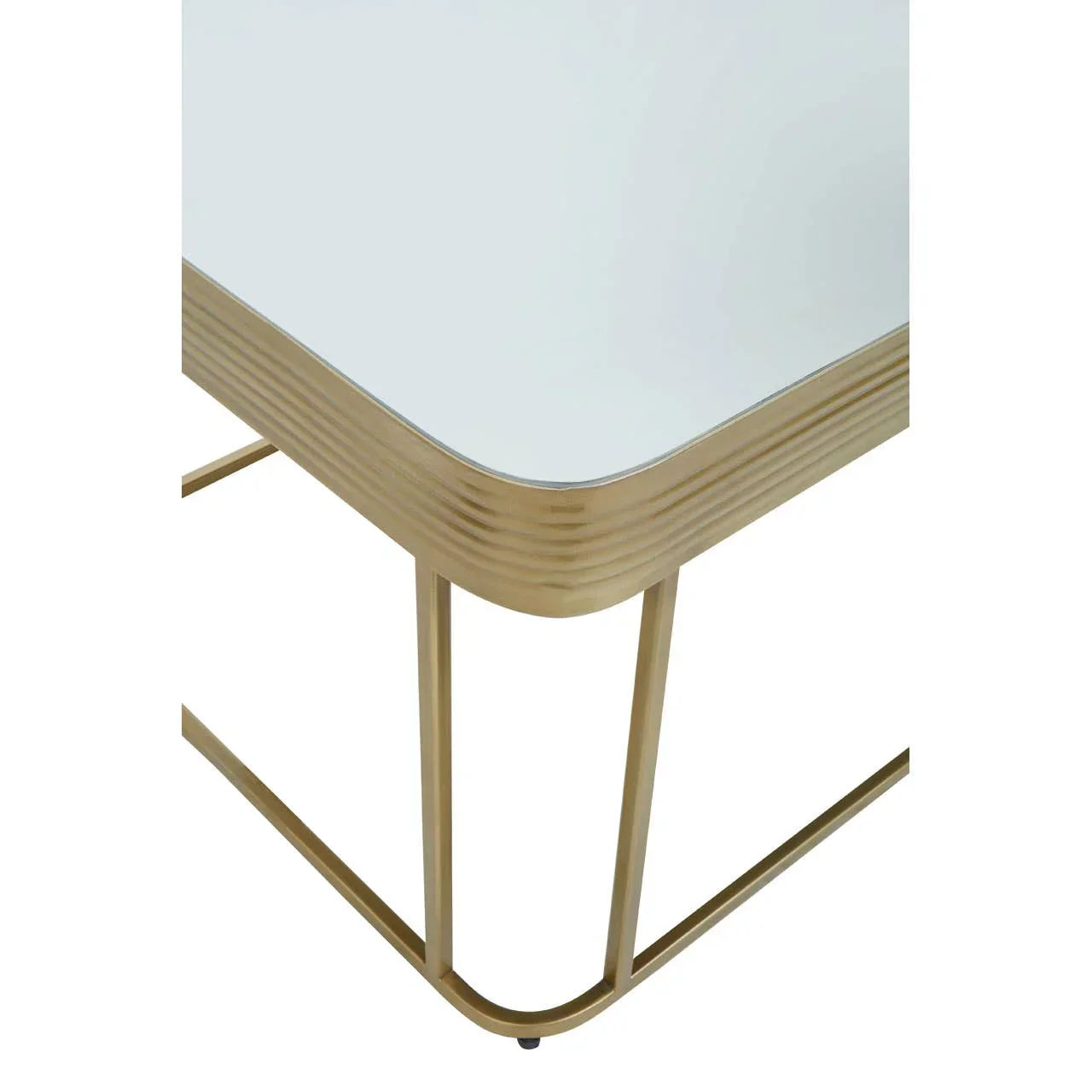 Glass top coffee table with gold metal frame, close-up of corner and leg design