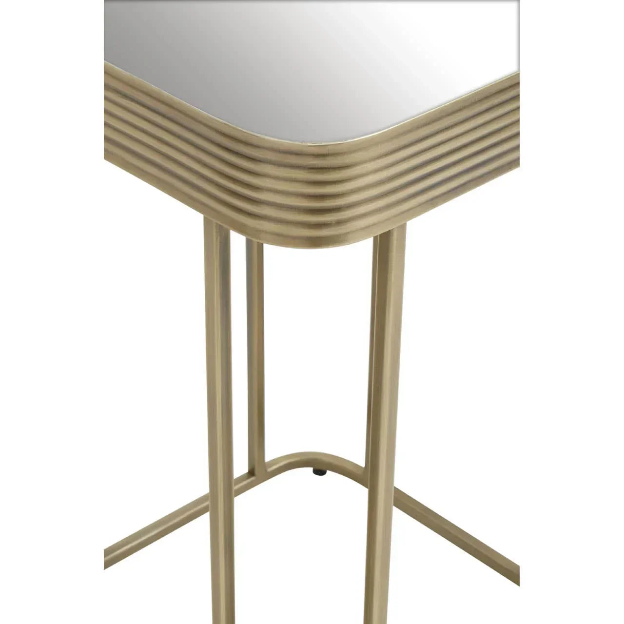Gold metal side table with ribbed edge detail and mirrored top, close up of legs and corner