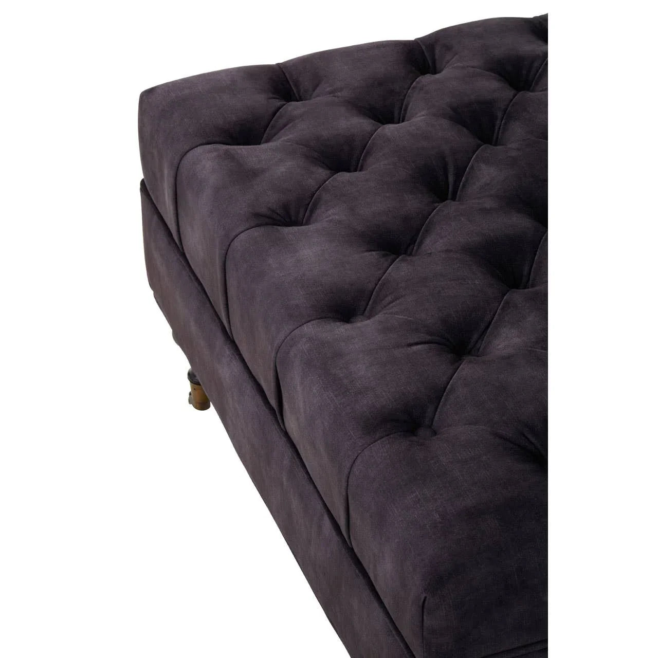Dark grey tufted fabric ottoman with wooden feet, close-up of cushioned top
