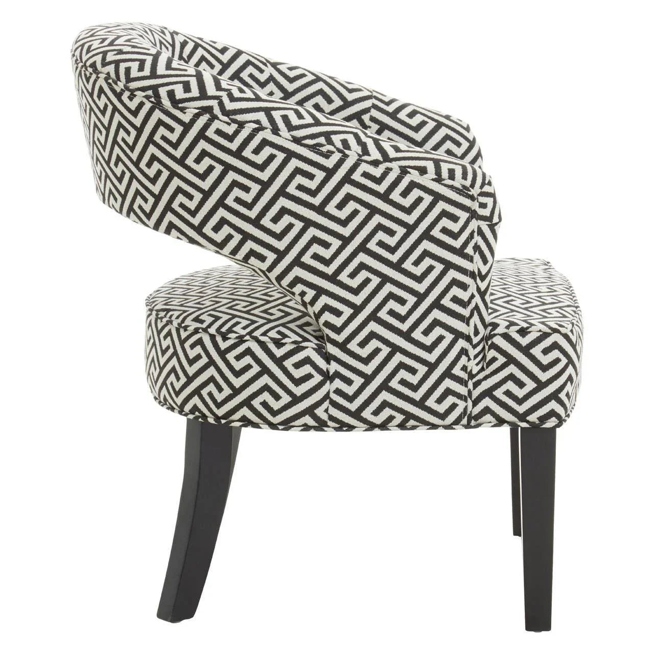Accent chair with black and white geometric upholstery, side view, dark wooden legs