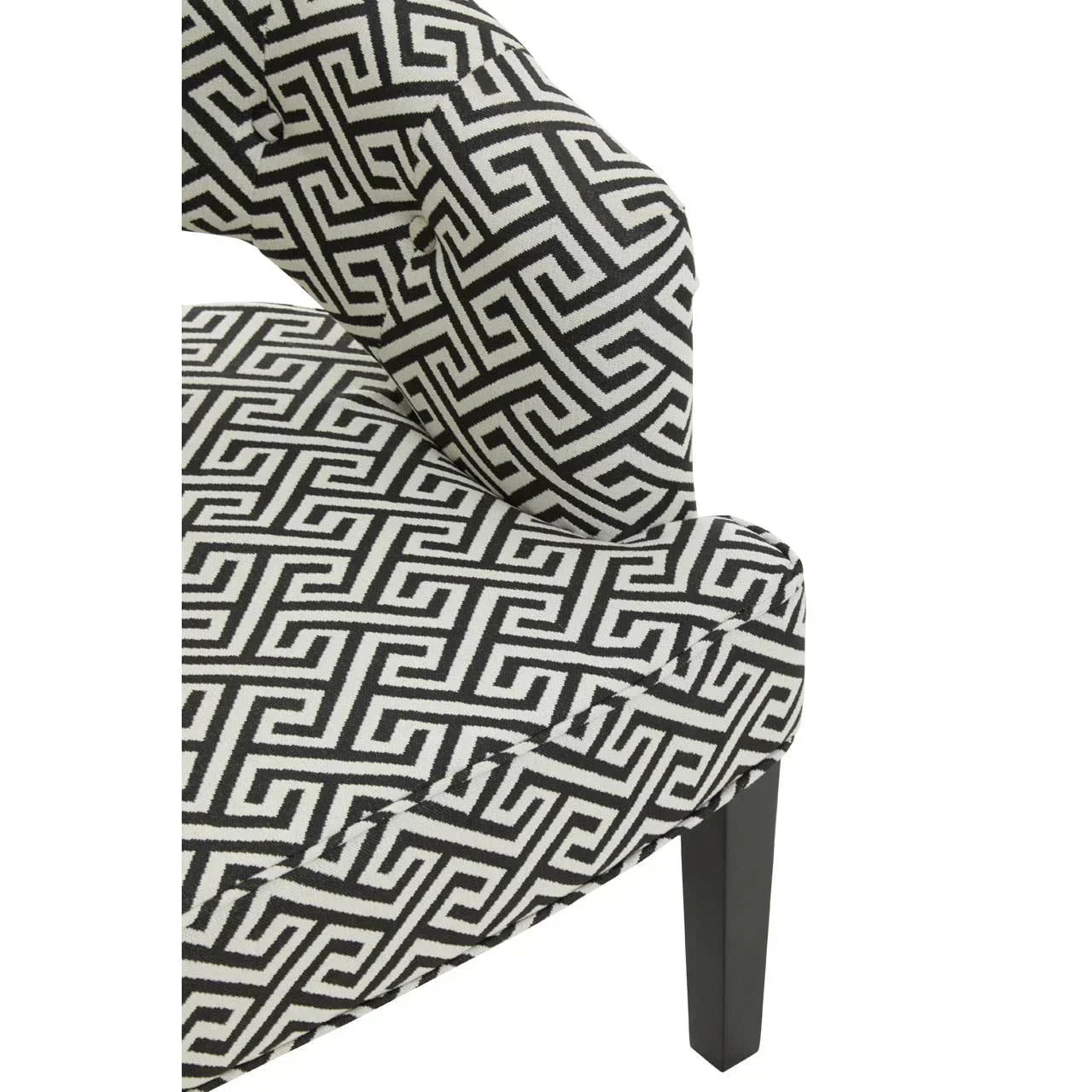 Black and white geometric fabric armchair with dark wooden leg, close-up of upholstery