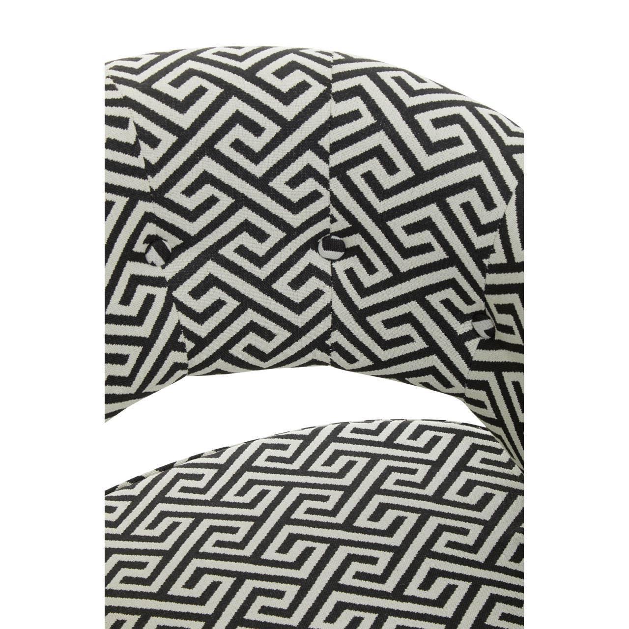 Close-up of patterned fabric dining chair backrest with black and white geometric design