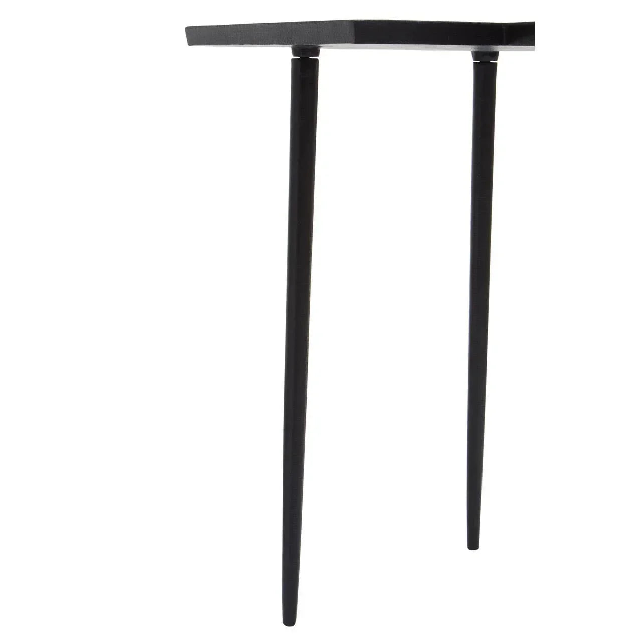 Closeup of black metal table legs and corner of tabletop