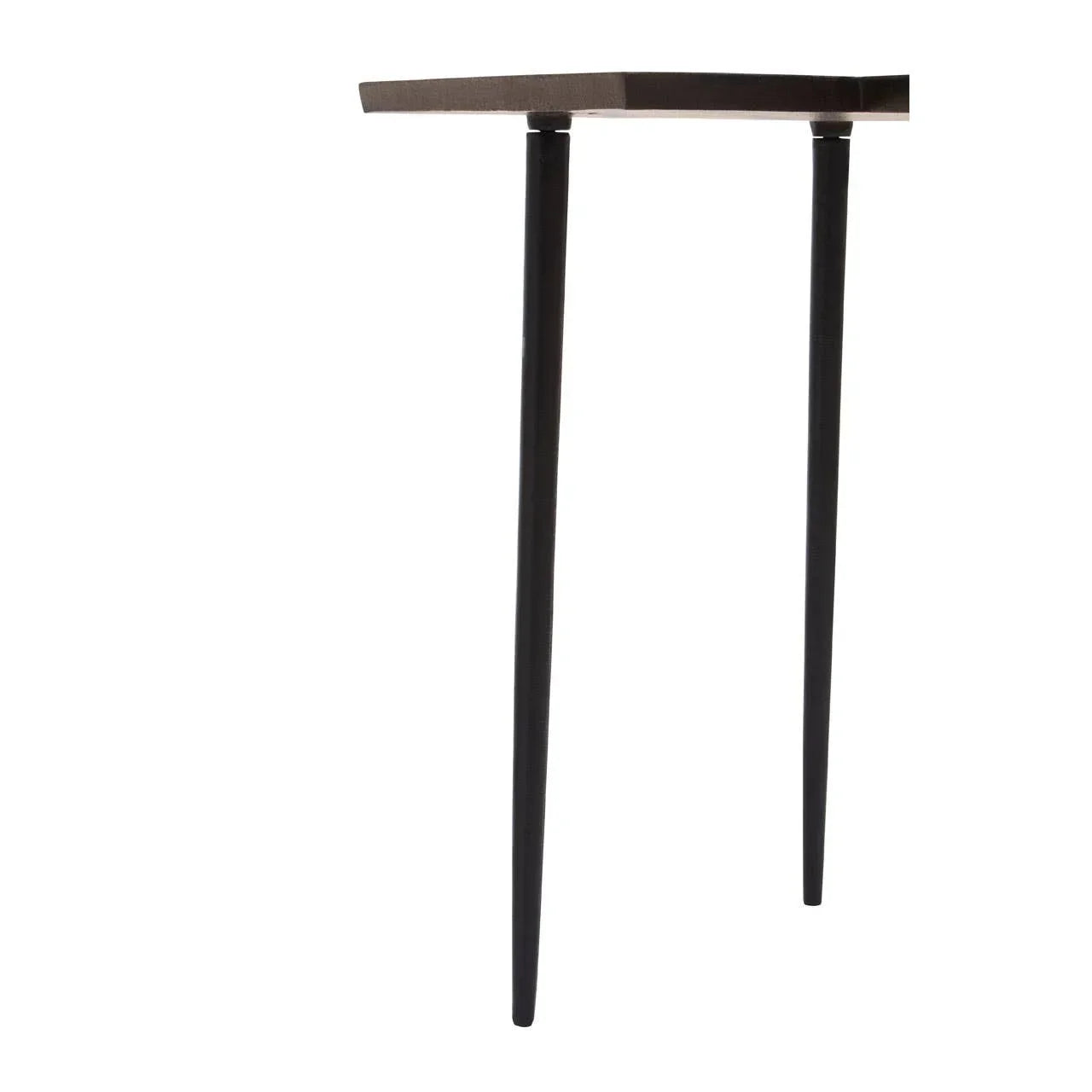 Closeup of black metal table legs beneath dark wood tabletop