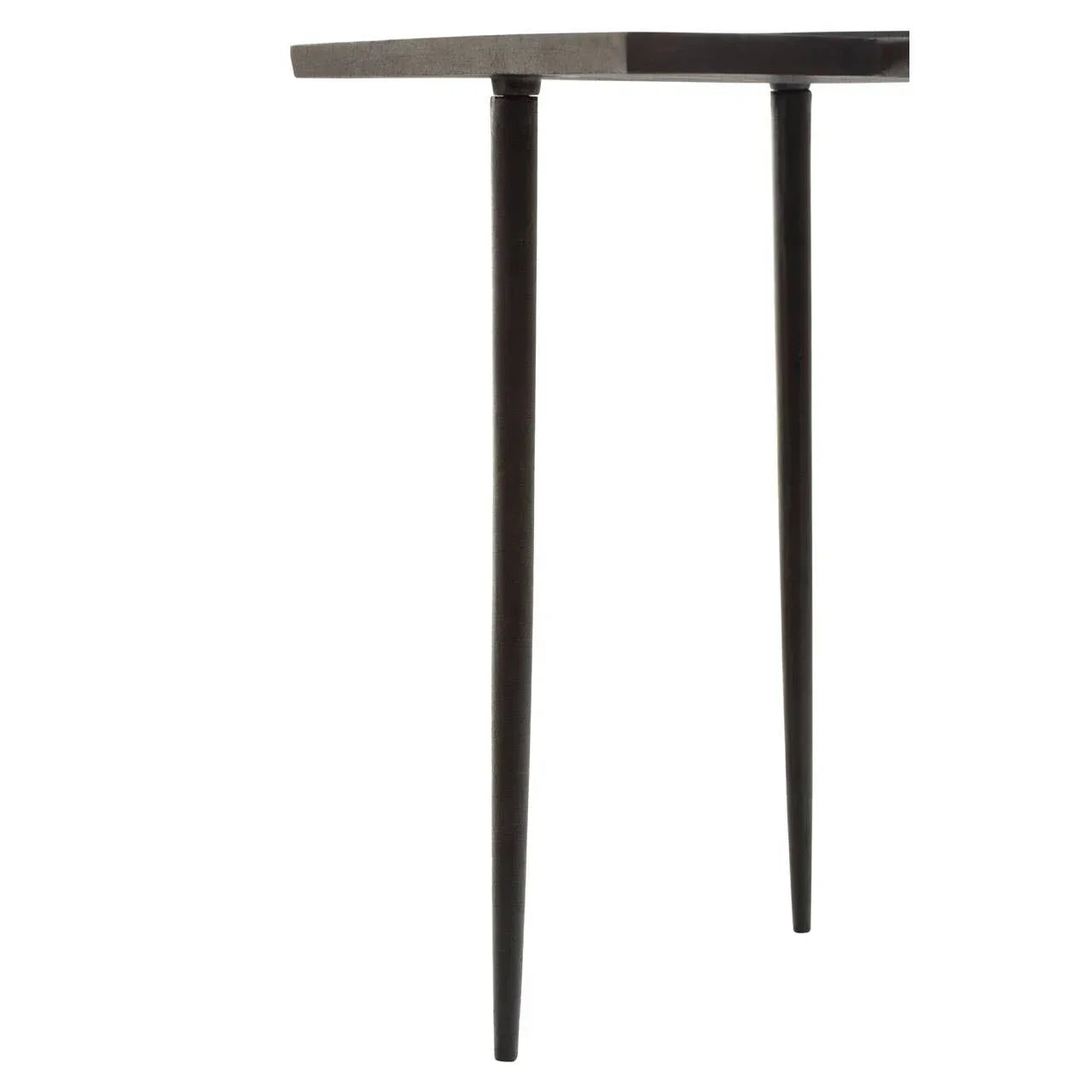 Closeup of black dining table legs with slim tapered metal design