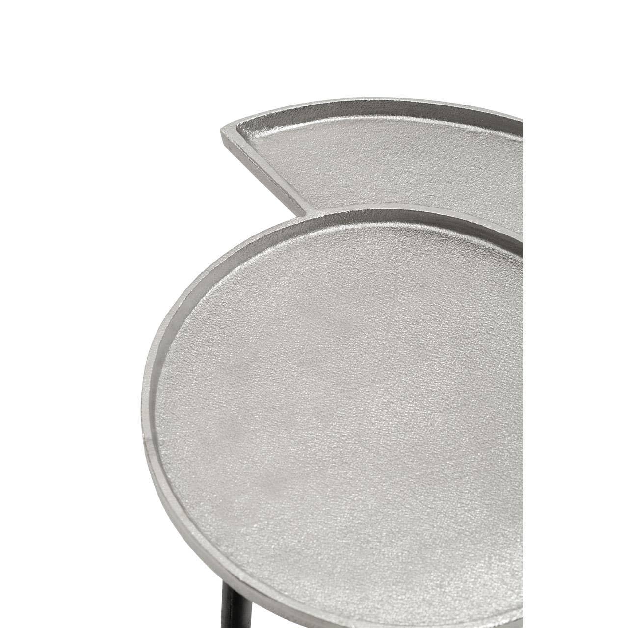 Close up of silver metal nesting table top with textured finish and partial overlap design