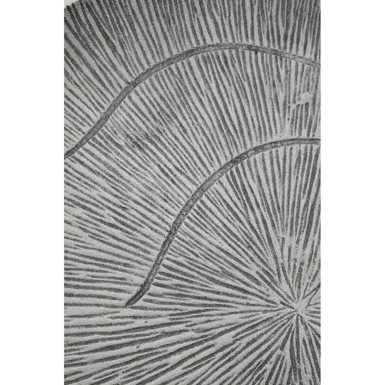 Grey patterned rug closeup showing textured sunburst design and raised linear details
