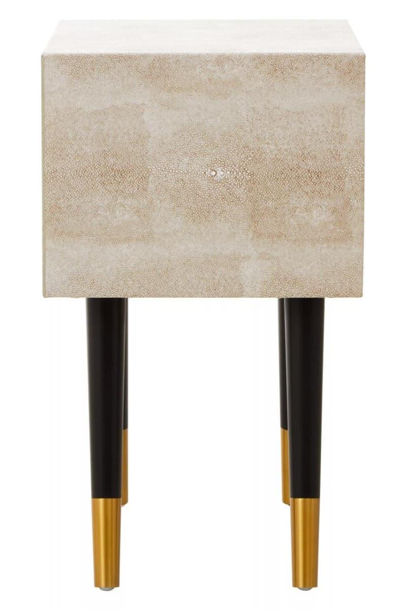 Textured beige bedside table with black legs and gold tips, front view