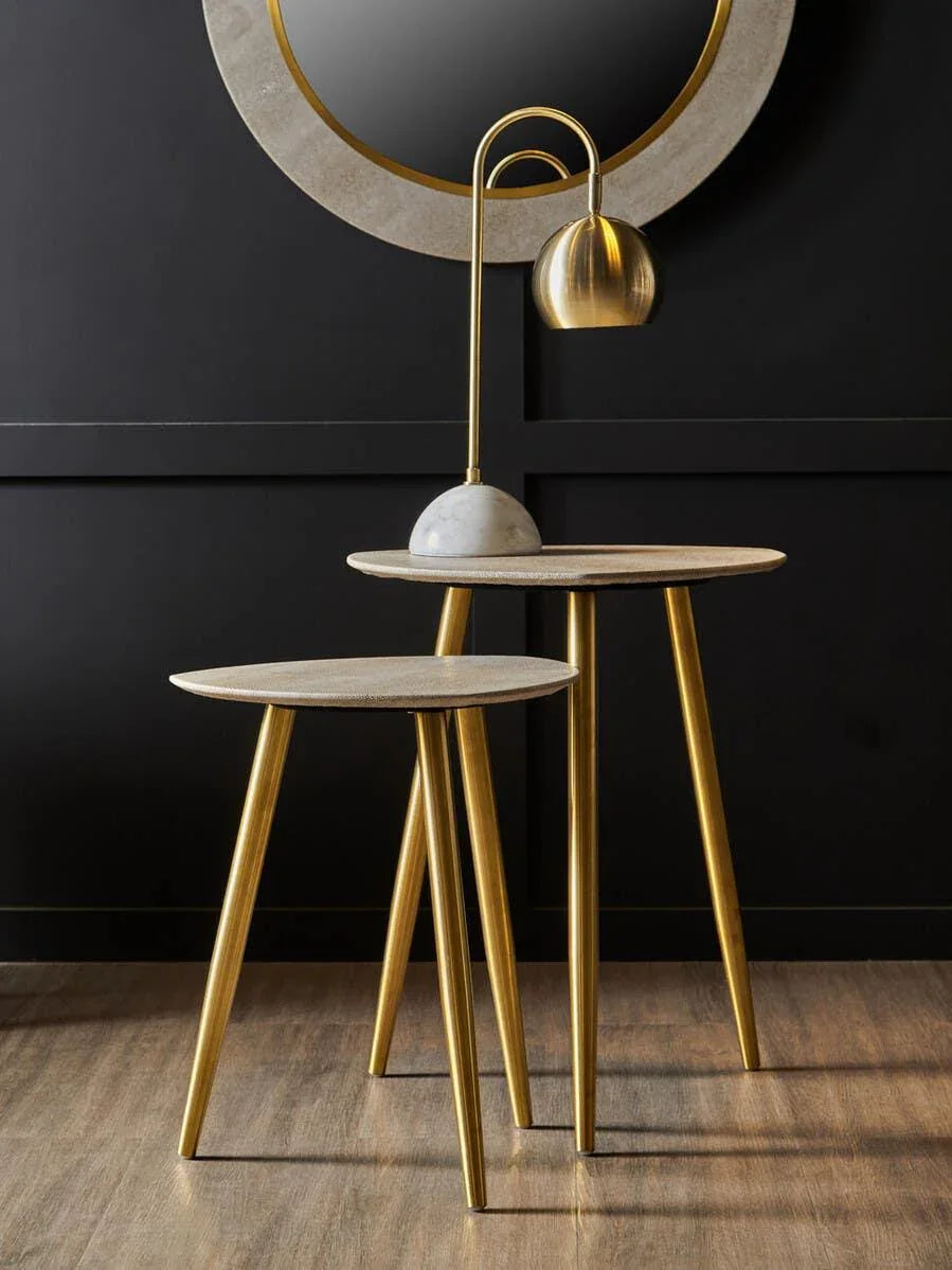 Set of two gold accent tables with marble tops and a modern gold table lamp