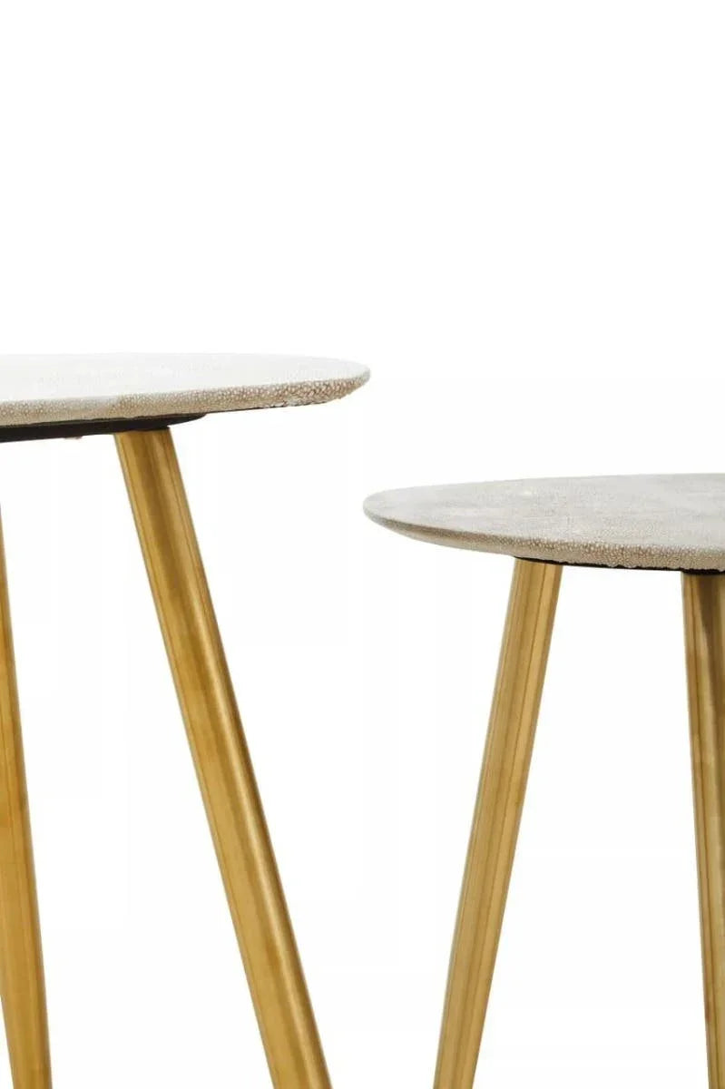 Set of two nesting side tables with light textured tops and gold metal legs