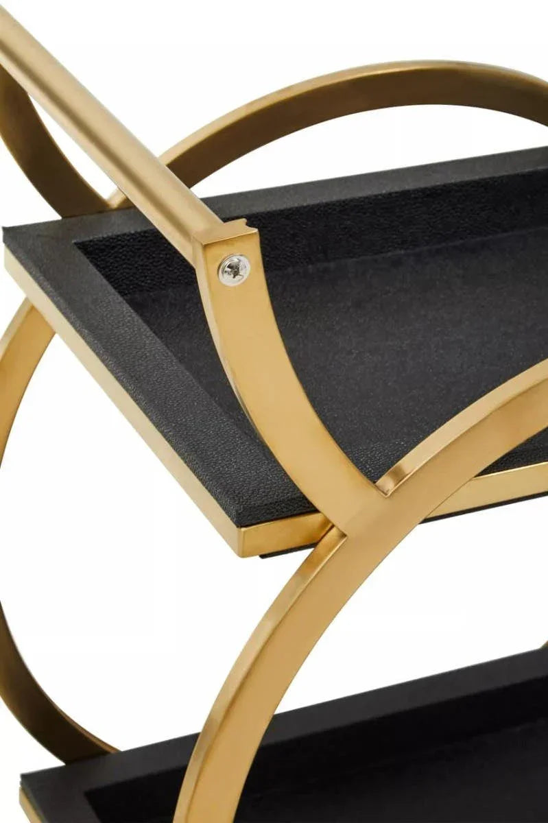 Close up of gold metal frame and black shelves on modern drinks trolley