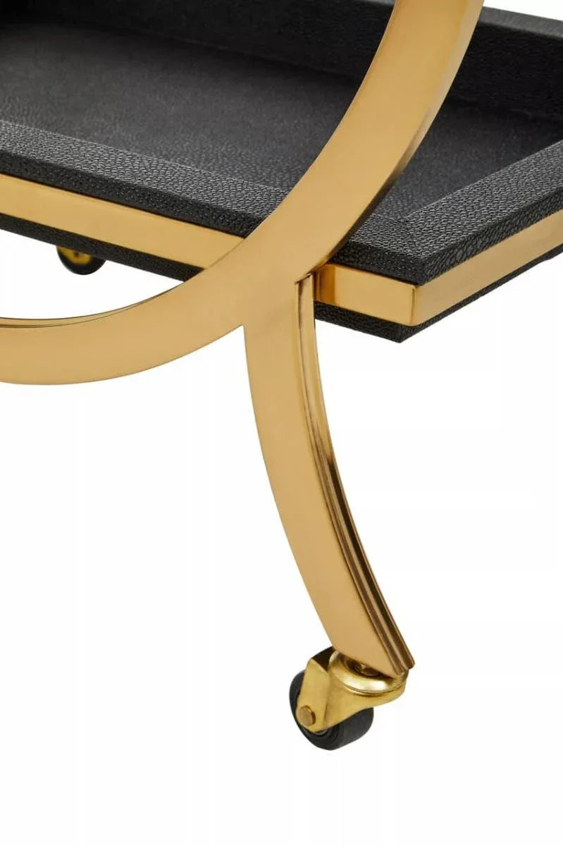 Gold metal bar cart leg with caster wheel and textured black shelf detail