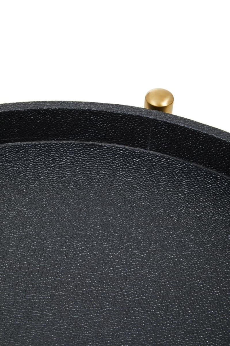 Close-up of textured black tray with gold metal handle detail