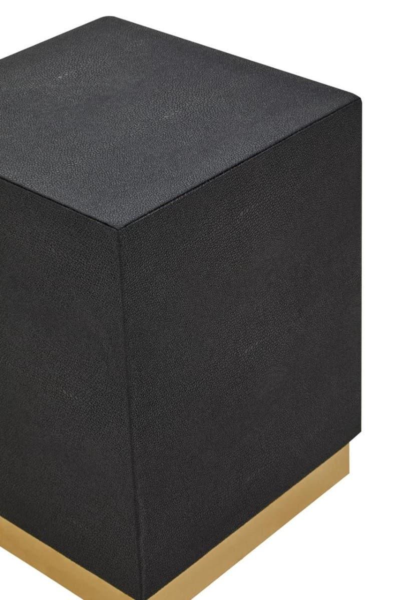 Black cube side table with textured finish and gold base corner view