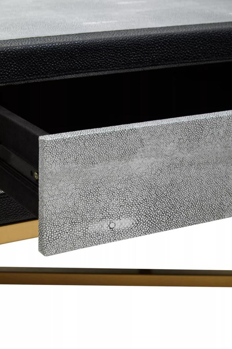 Textured drawer front on modern side table with metallic gold base