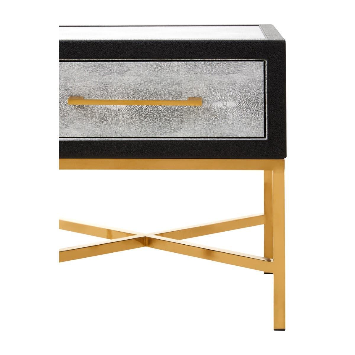 Modern bedside table with gold metal legs and single drawer in textured finish