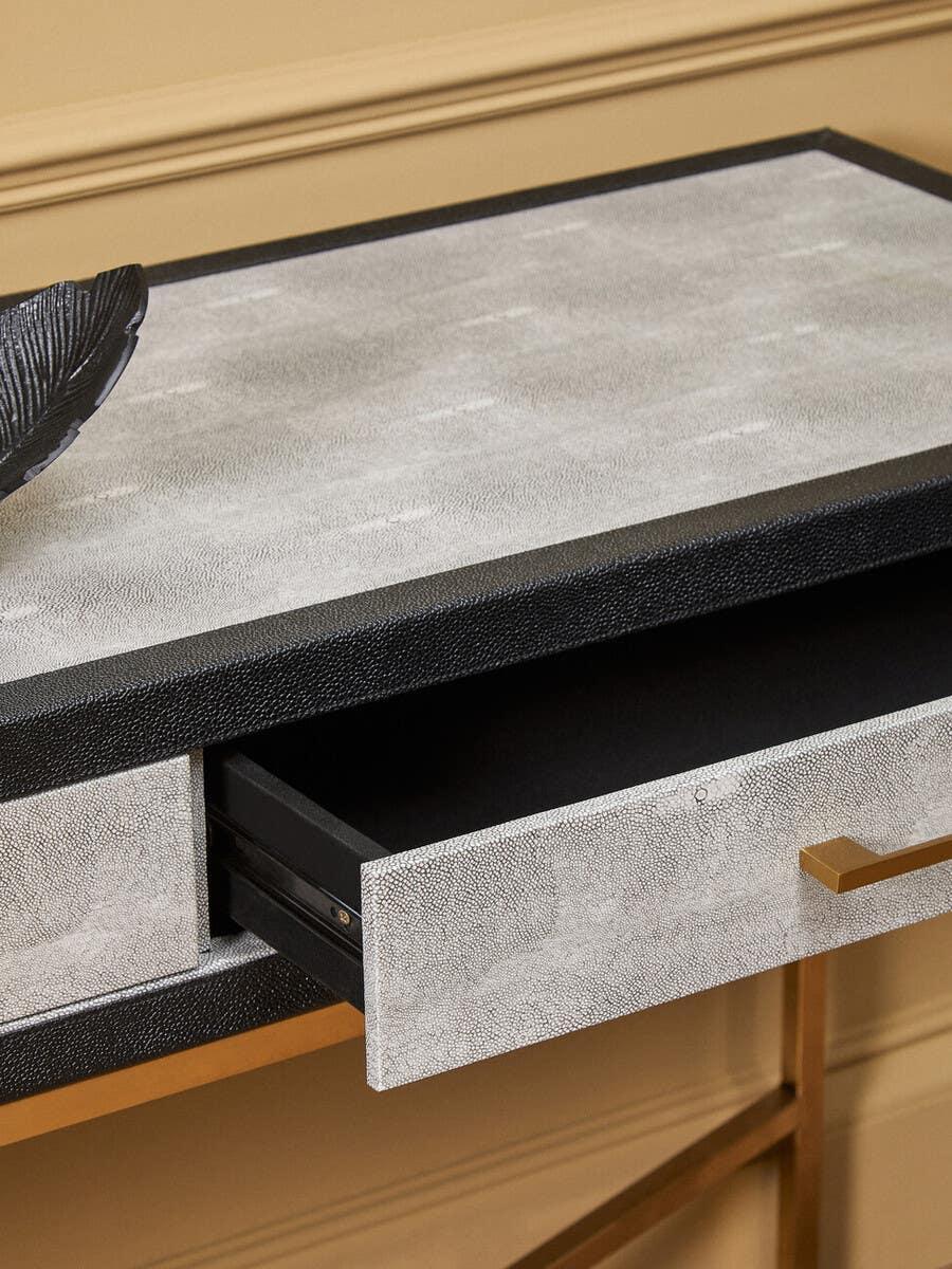 Textured console table in grey and black with open drawer and gold handle