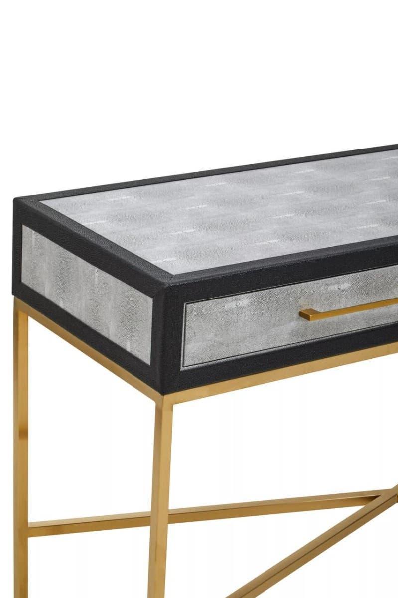 Modern console table with gold metal legs and textured silver drawer front