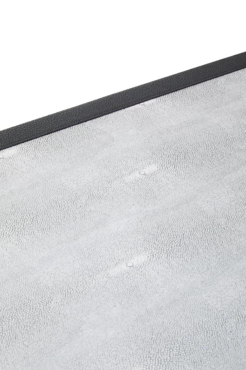 Close up of textured grey tabletop surface with black edge, modern furniture detail