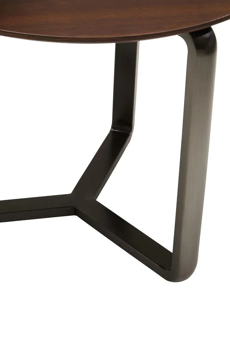 Round wooden coffee table with metal legs, close-up on dark frame and tabletop edge