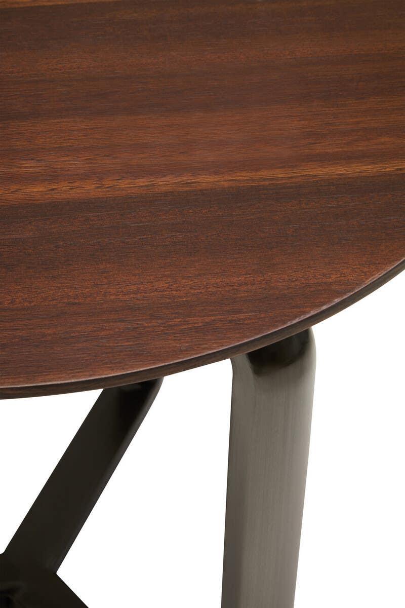 Walnut wood dining table top with rounded edge and dark metal legs, close-up view