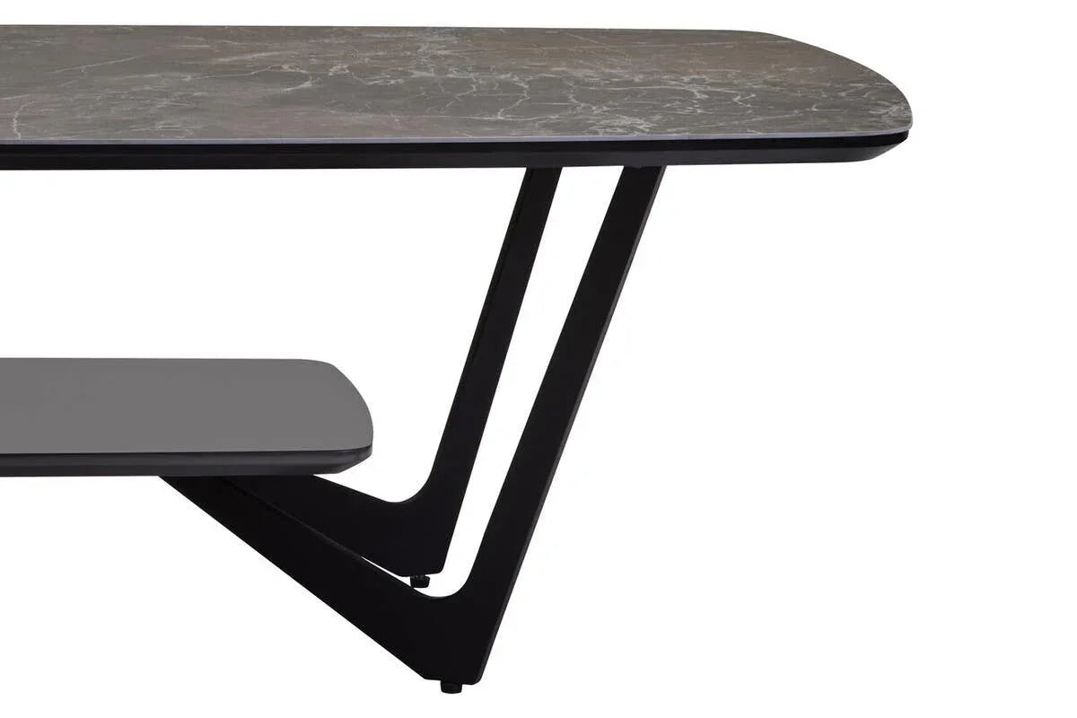 Modern marble dining table with black angled legs and lower shelf, close-up view