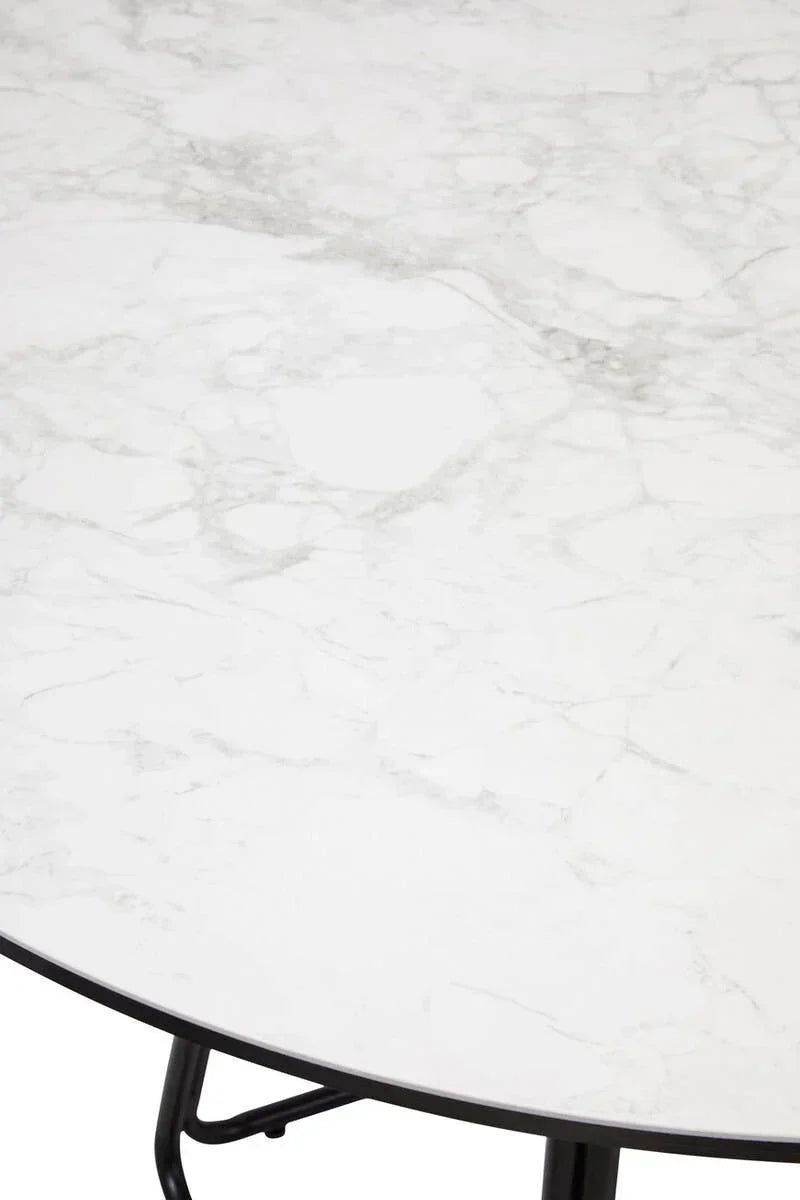 Round marble dining table top with black metal legs, close-up detail view