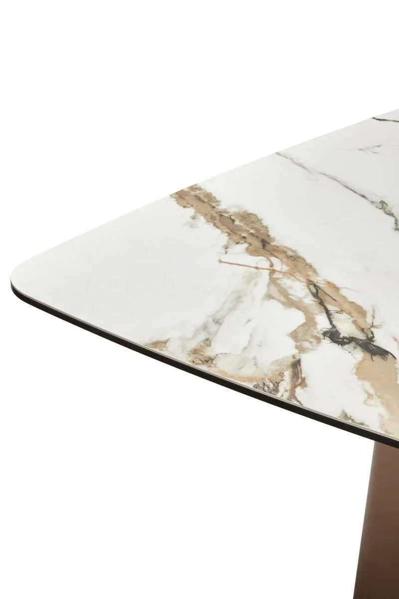 Corner detail of rectangular marble dining table with white and gold veining