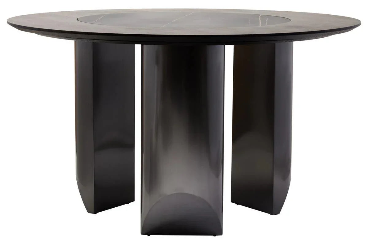 Round black dining table with four sturdy pedestal legs and a matte finish
