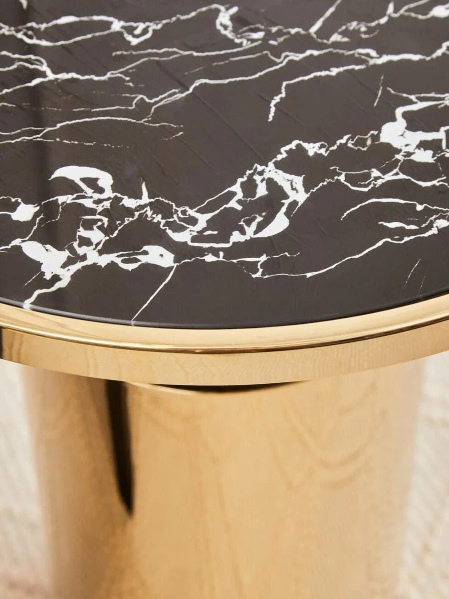 Black marble side table with gold cylindrical base and white veining details