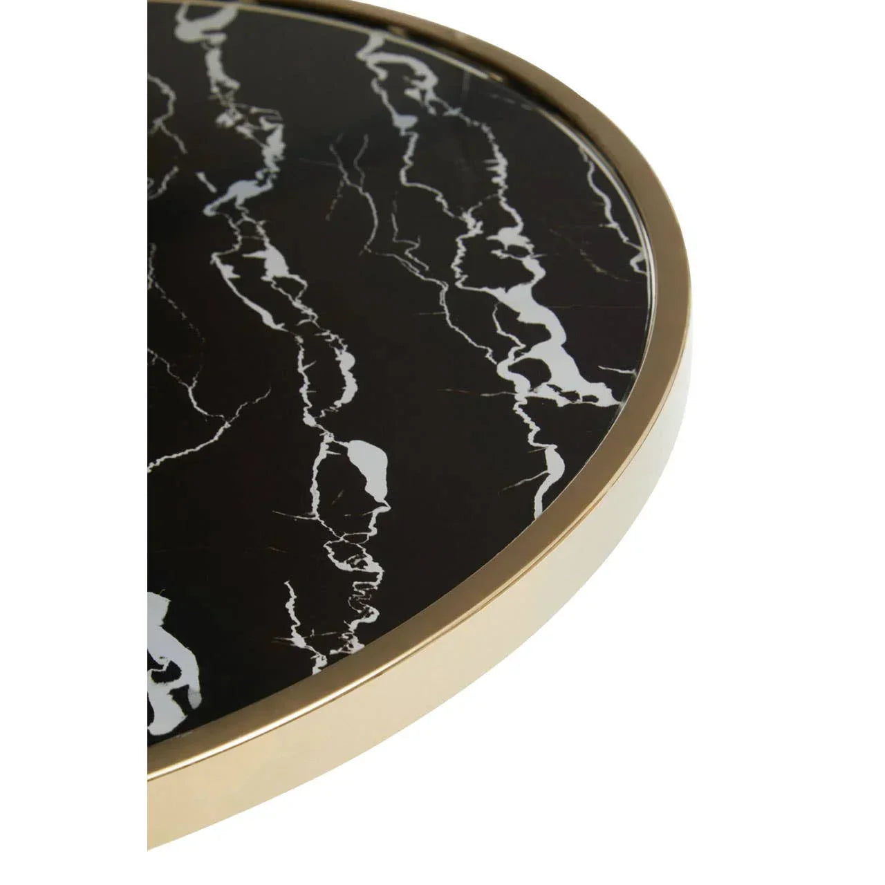 Round black marble table top with gold metal edge, close-up of surface detail